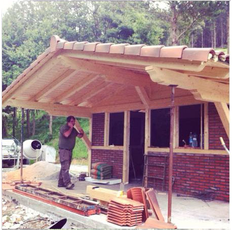 foto proceso construcción edificación con estructura de madera y ladrillos